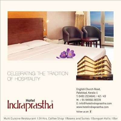 Hotel Indraprastha hospitality advertisement showing a room interior and hotel branding.